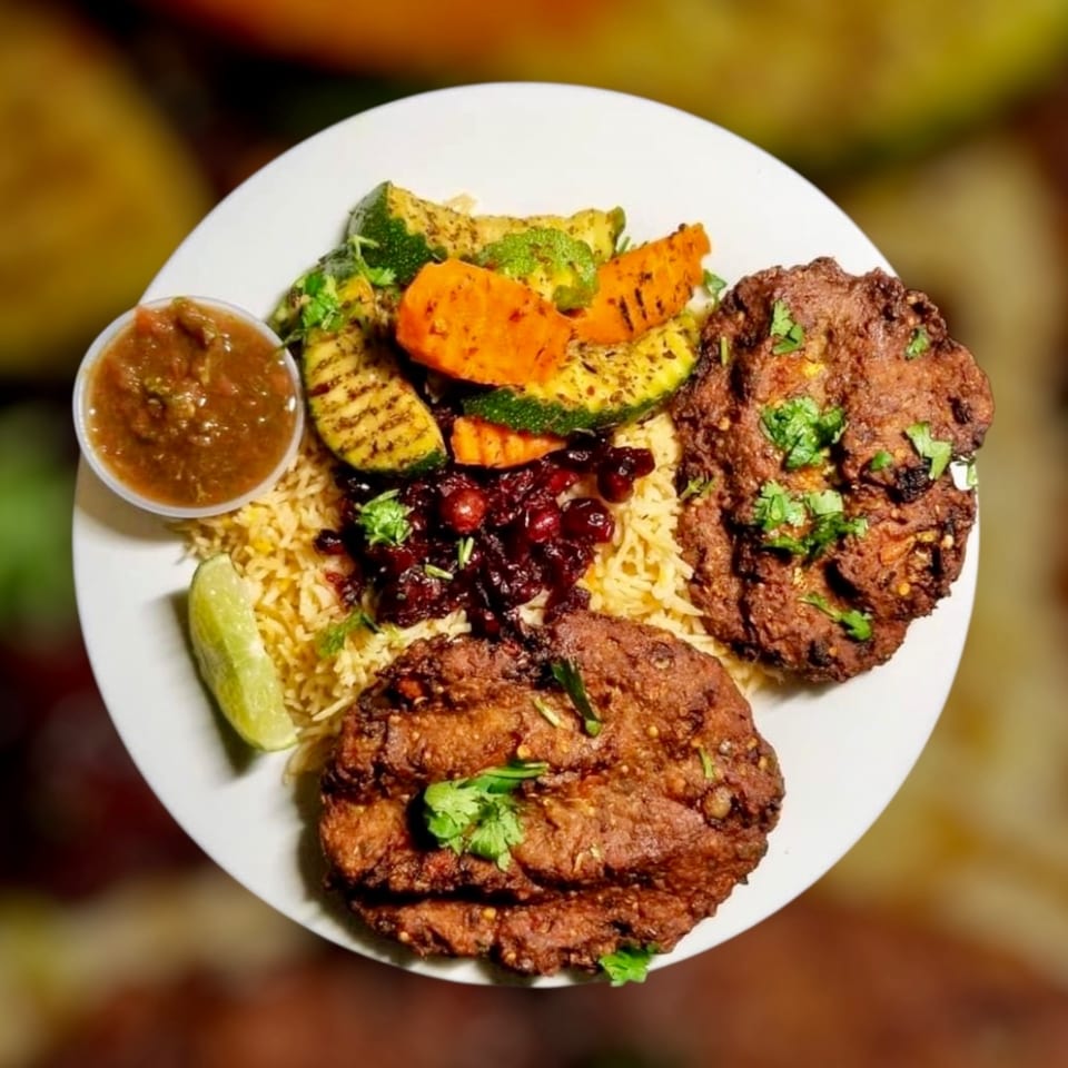 Maza Grill's halal platter with two grilled patties, rice, grilled vegetables, and salsa.