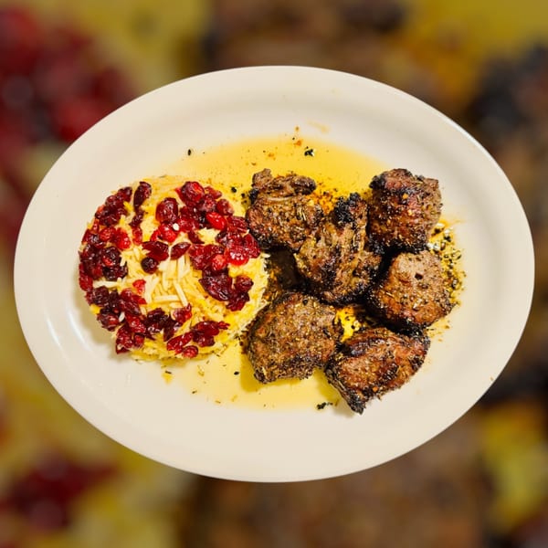 Maza Grill's halal grilled meat with rice and cranberries on a white plate.