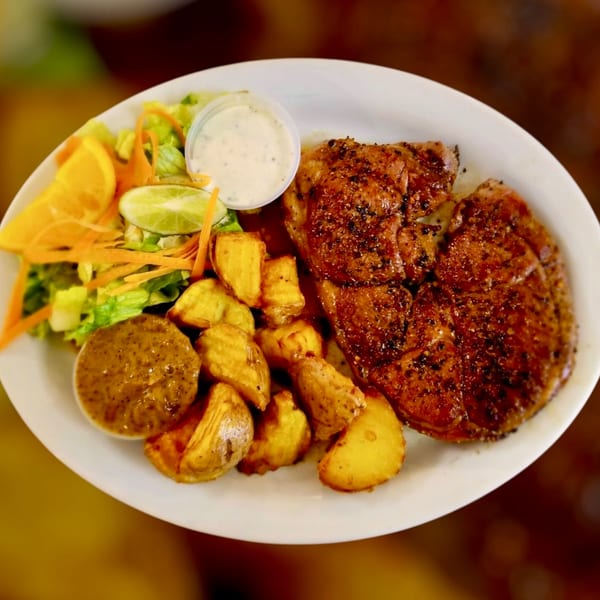 Maza Grill's halal grilled chicken with roasted potatoes, salad, and two dipping sauces.