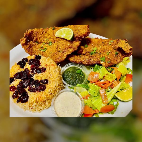 Halal fried fish with rice, dried cranberries, a side salad, and two dipping sauces.